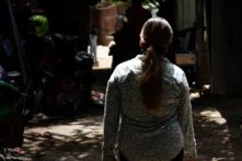 Kruy Phal walks in her community at Boeng Tompun. 