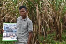 Teng Kao stands on his land 