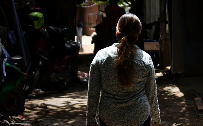 Kruy Phal walks in her community at Boeng Tompun.