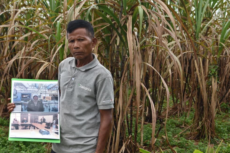 Teng Kao stands on his land
