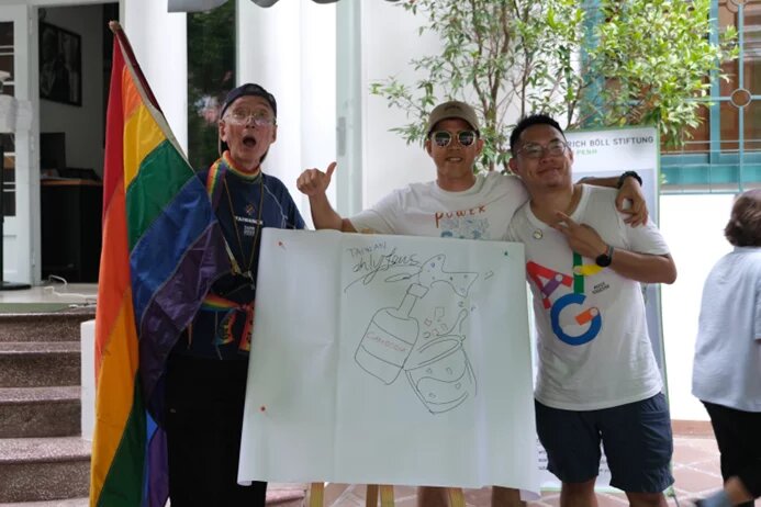 A Pride tuk-tuk and participants of the Pride race in front of hbs office