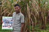 Teng Kao stands on his land 