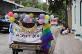 A Pride tuk-tuk and participants of the Pride race in front of hbs office.